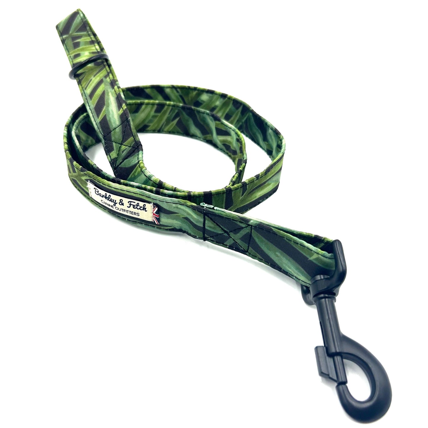 A dog lead with a tropical print in green and blue tones, featuring a metal trigger hook and a D-ring on the handle.