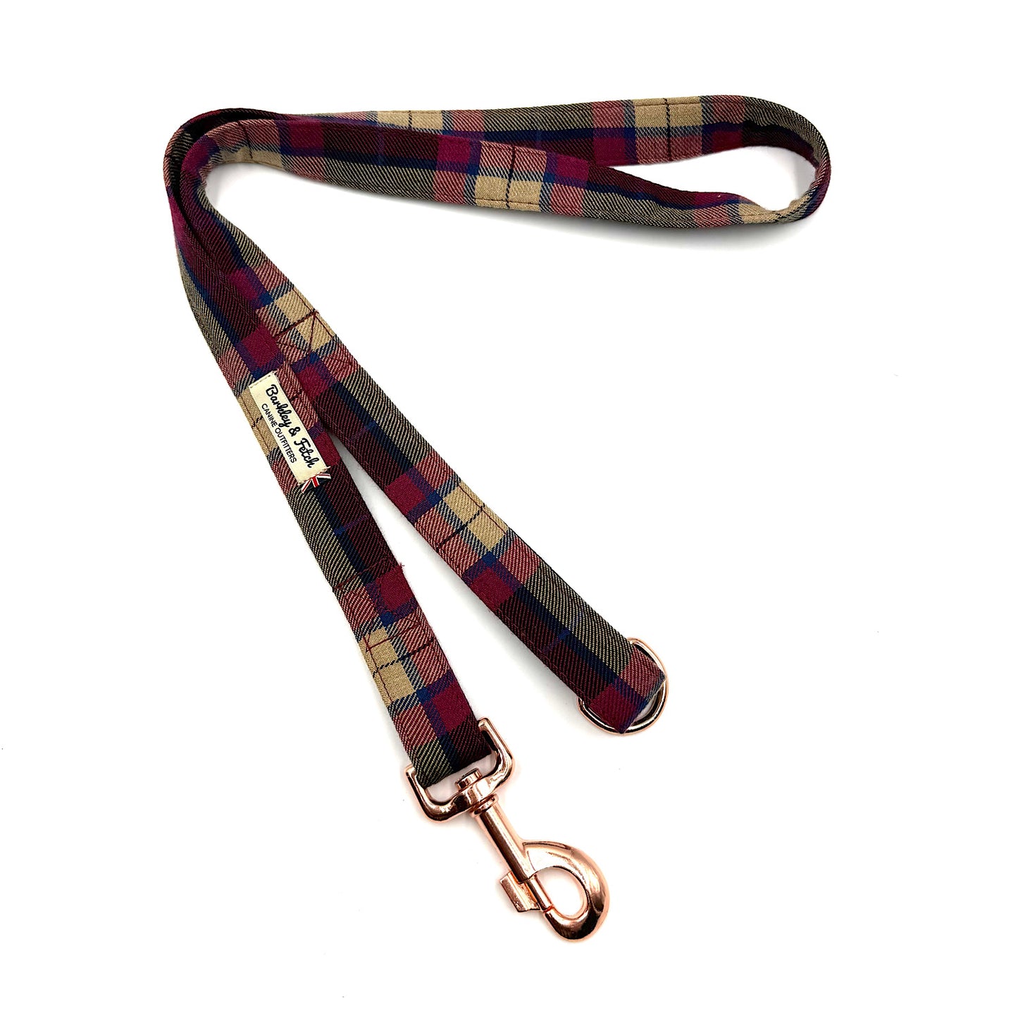 Plaid dog leash with rose gold clip on a white background