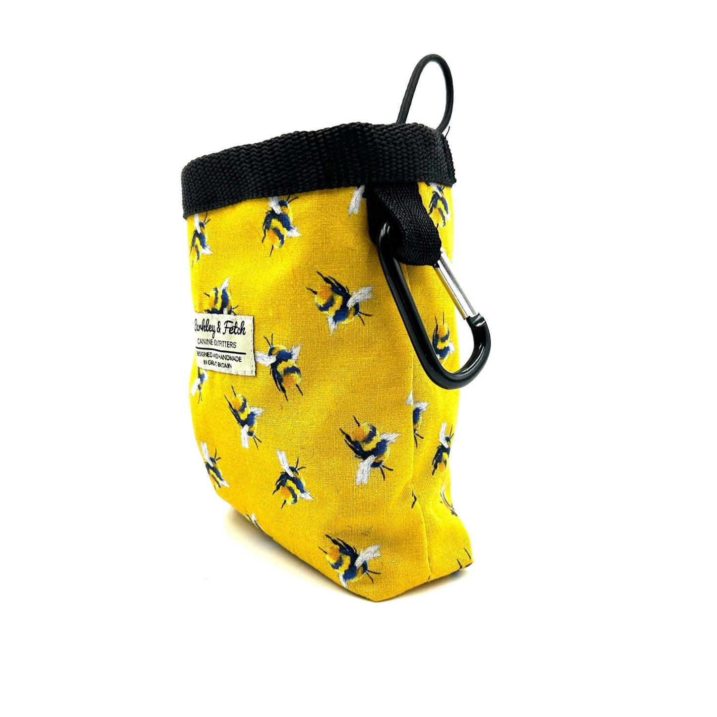 Yellow treat bag with bee pattern and carabiner on a white background