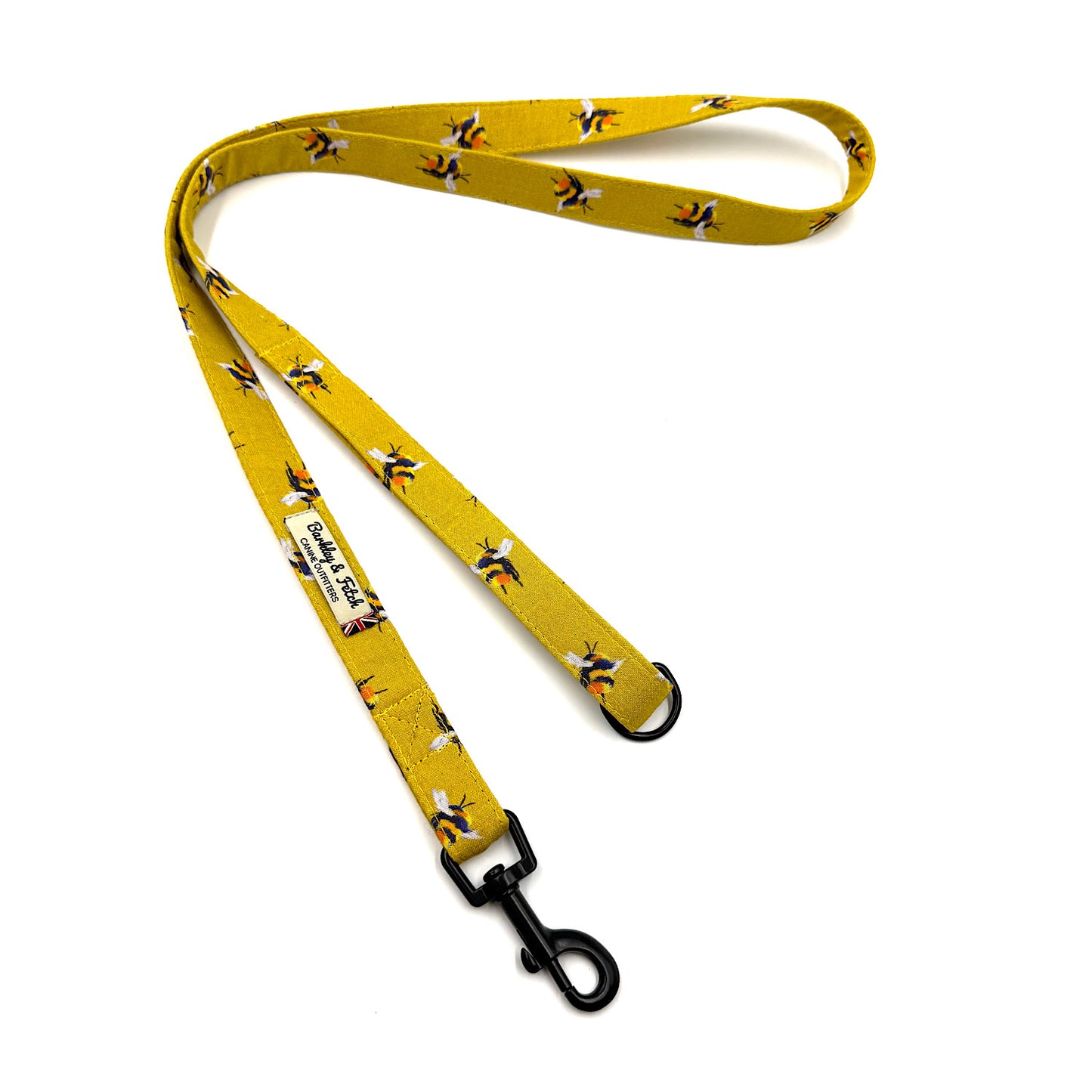 Yellow dog leash with bee pattern on a white background