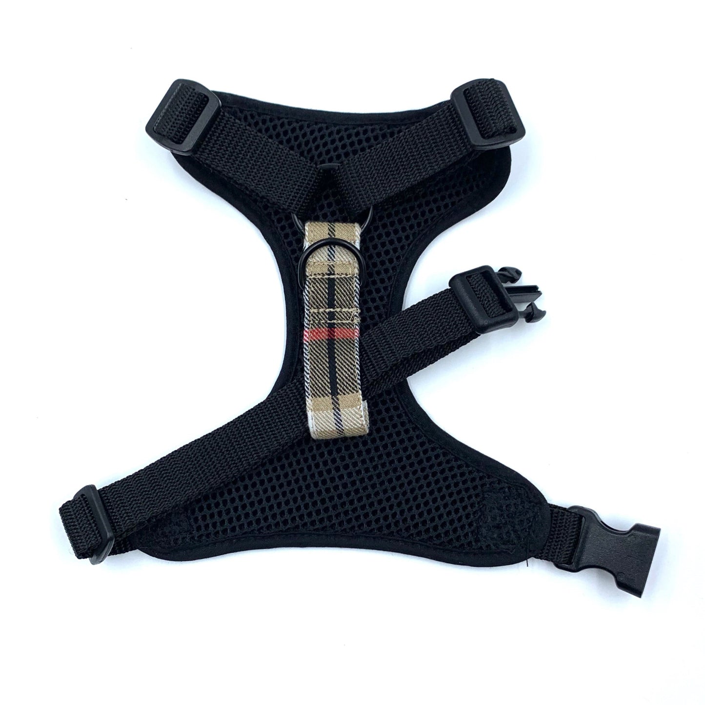 Black dog harness with plaid strap on a white background
