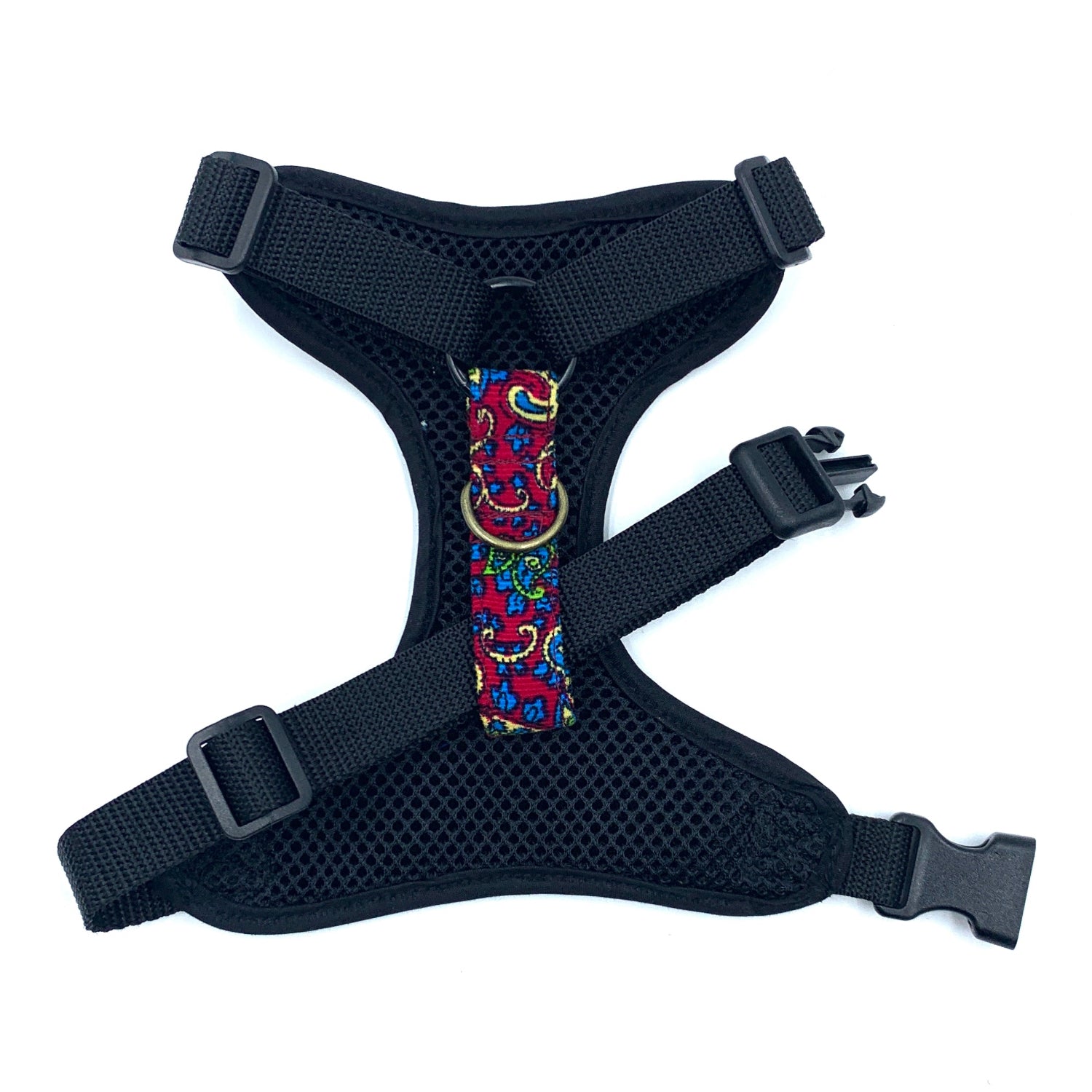 Black dog harness with colorful floral pattern on a white background