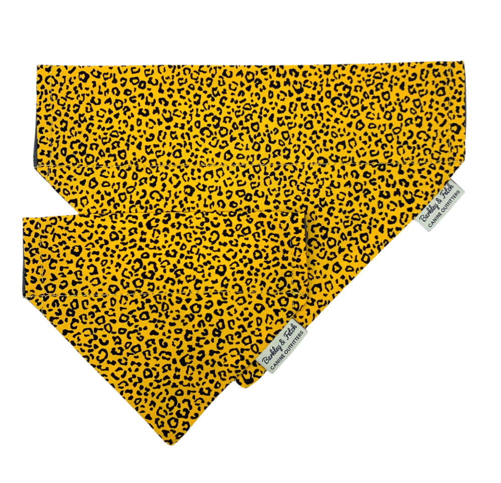 Yellow bandana with black leopard print pattern on a white background