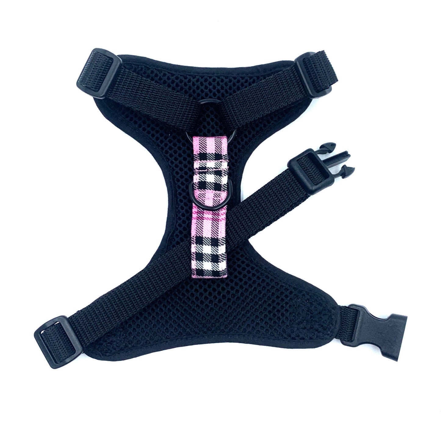 Black dog harness with a pink plaid bow on a white background