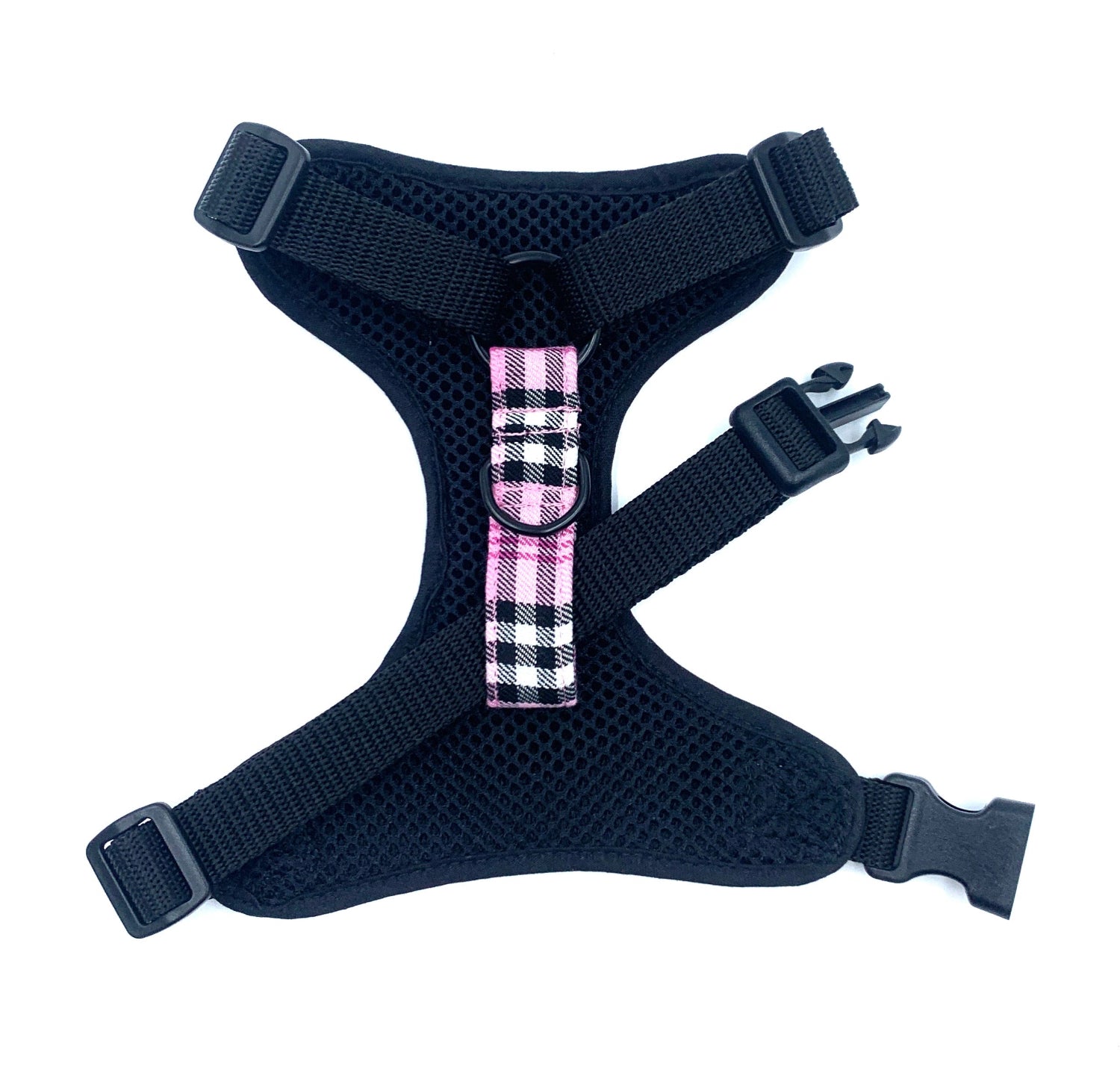 Black dog harness with a pink plaid bow on a white background