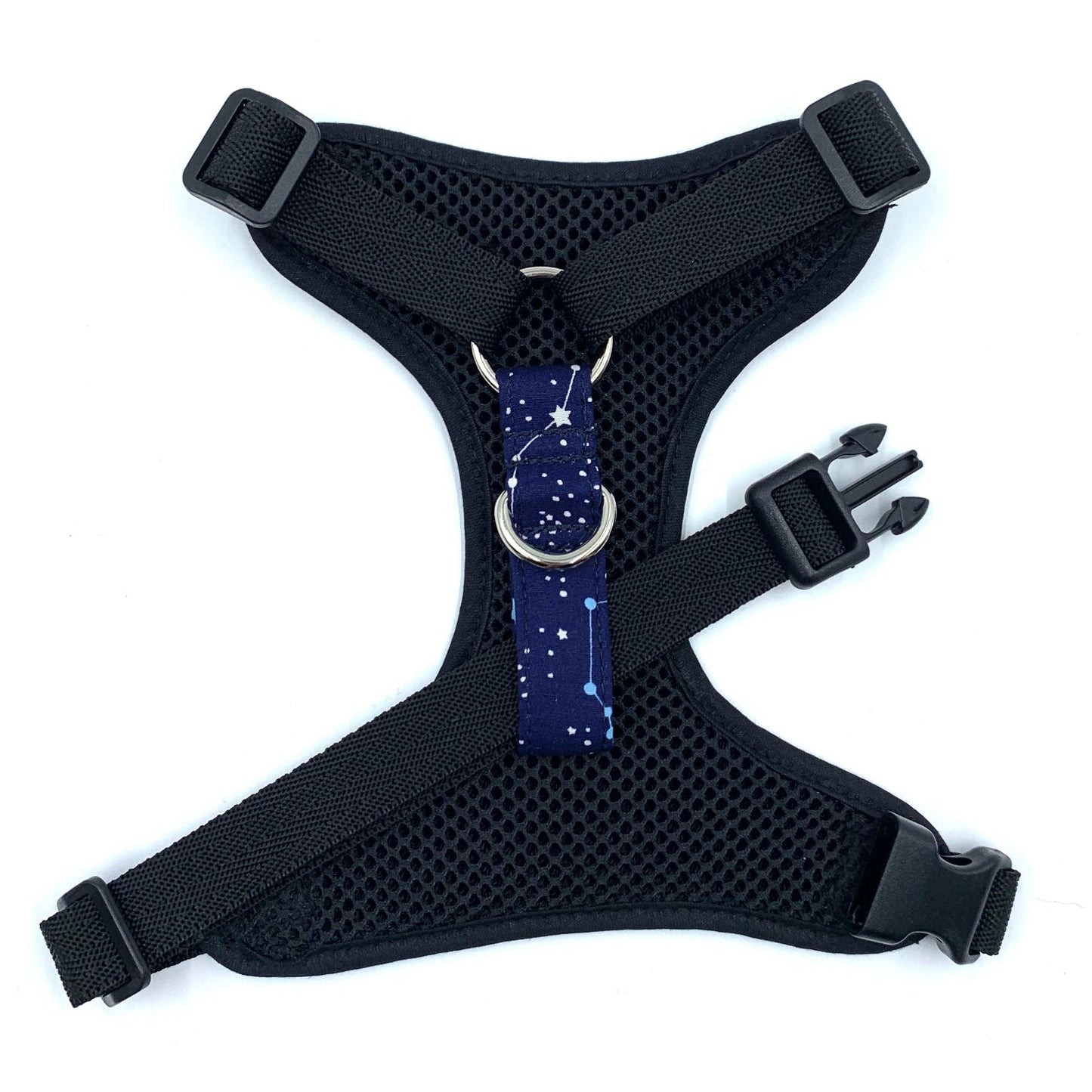 Black dog harness with a blue star-patterned patch on a white background