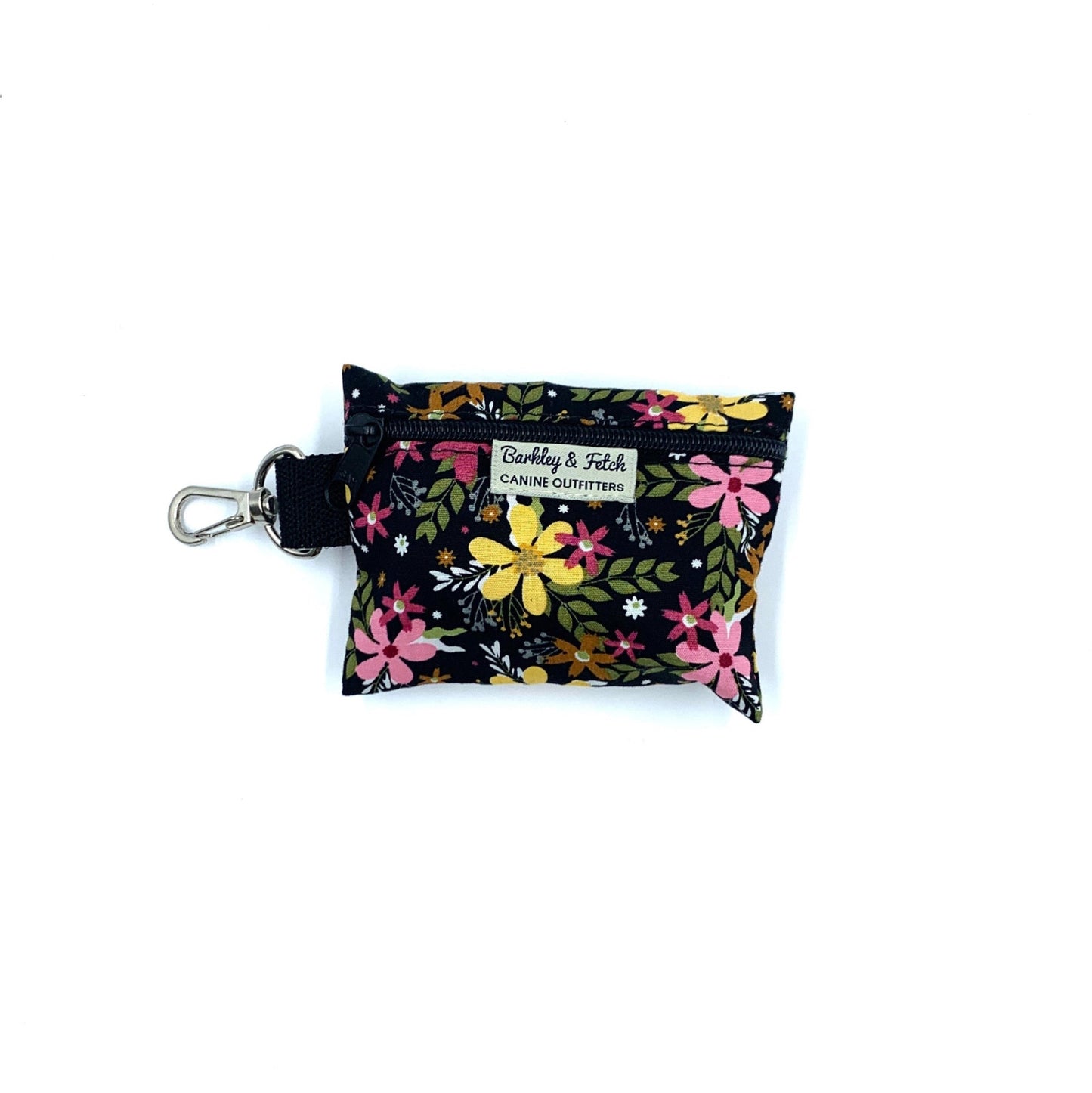 Floral-patterned dog waste bag dispenser with a key ring on a white background