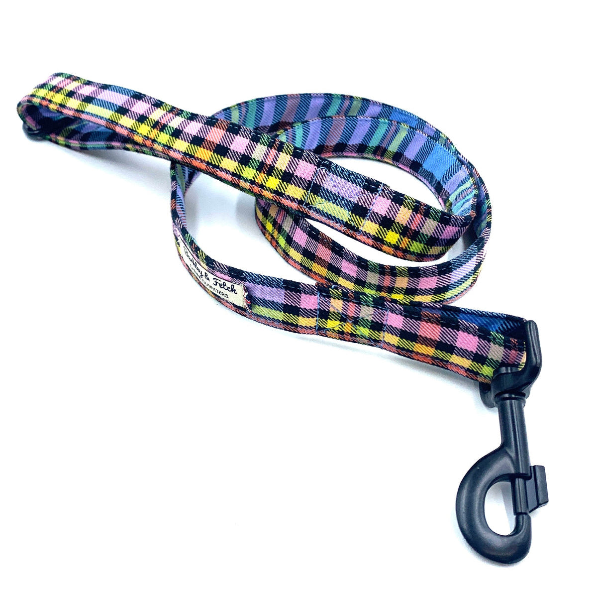 A pastel rainbow check dog leash with a metal trigger hook and a D-ring on the handle.