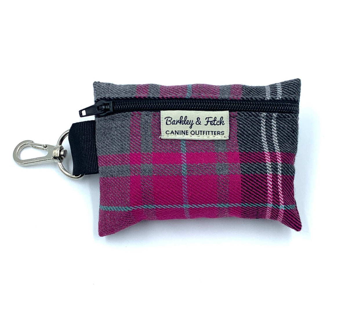 A pink and grey tartan poo bag holder with a brand label 'Barkley & Fetch'. It has a clip attachment and is designed to hold a roll of poo bags.
