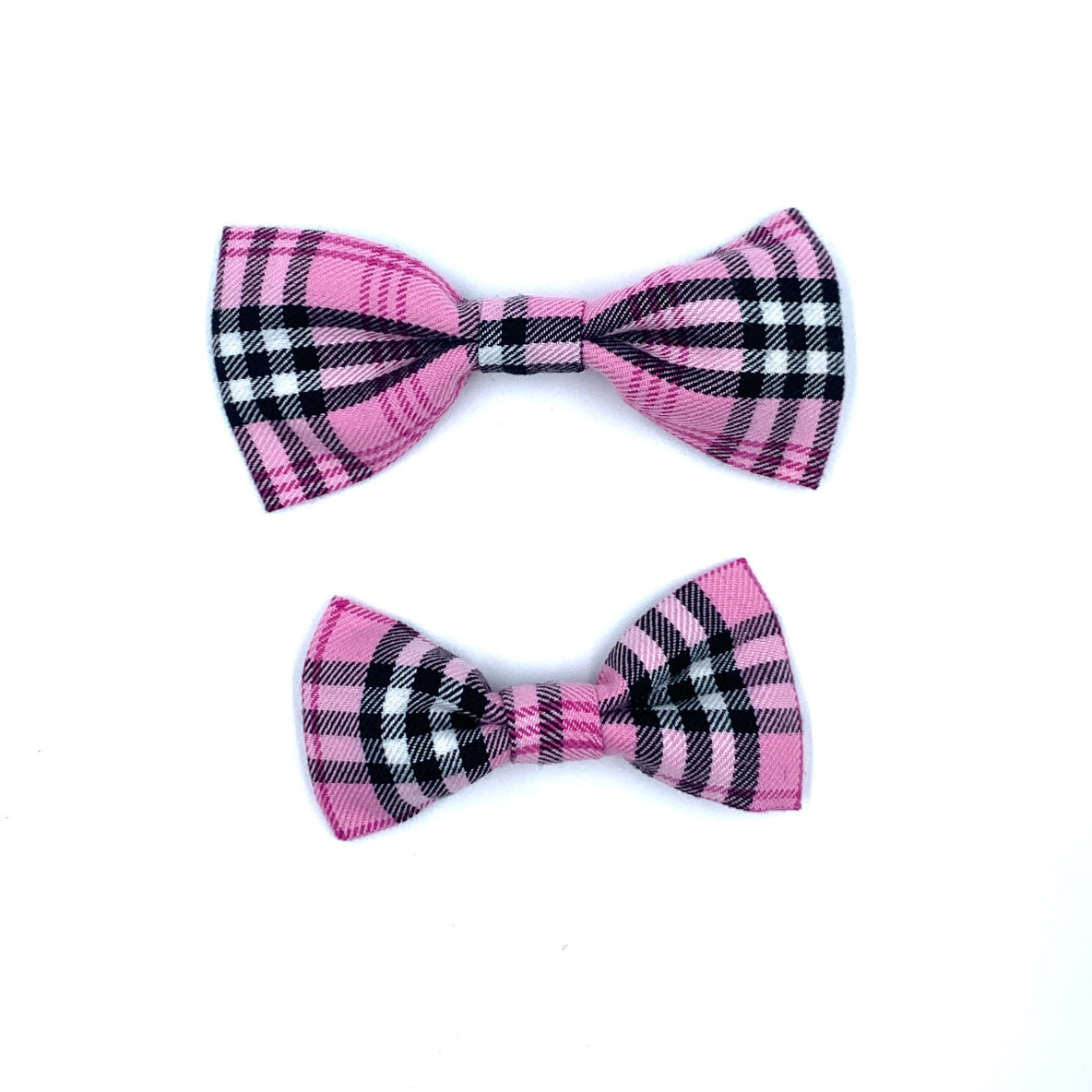 Two pink and black plaid bow ties on a white background