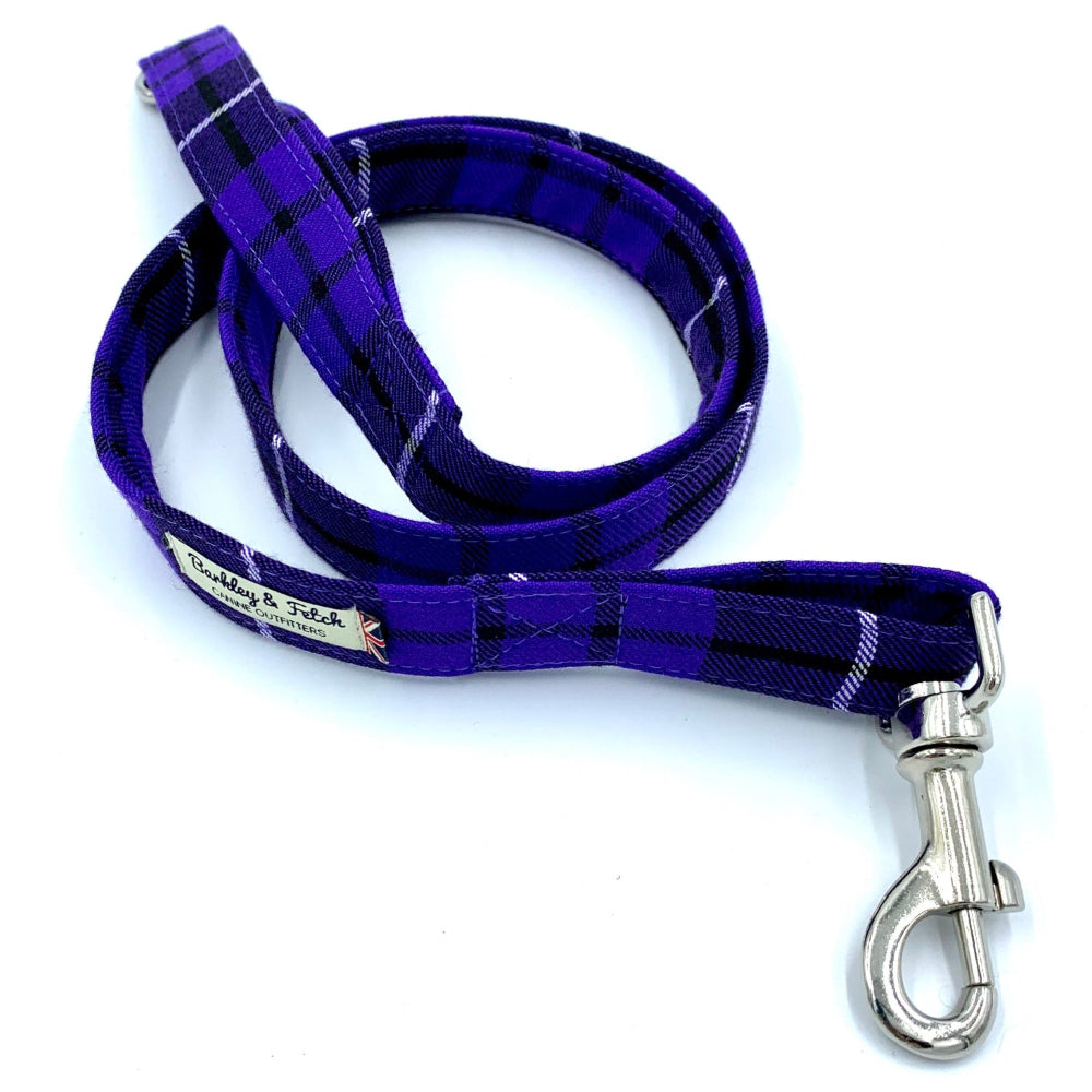 Purple plaid dog leash with a silver clasp on a white background