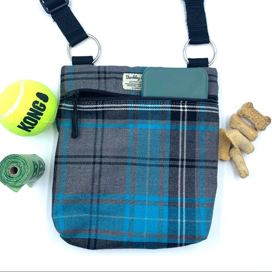 Plaid dog treat pouch with accessories on a white background