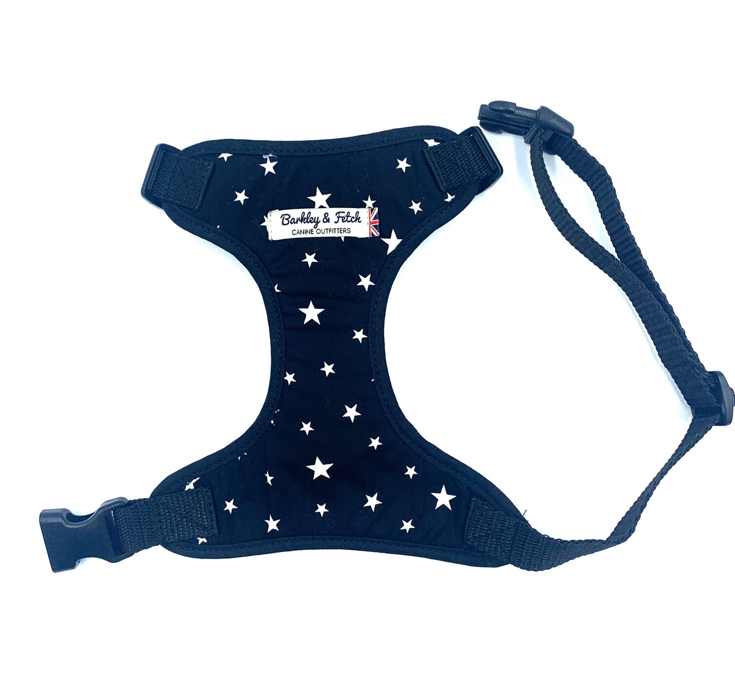 A black fabric dog harness with a star print, adjustable straps, and a heavy duty d-ring. It includes side release buckles and is branded with 'Barkley & Co'.