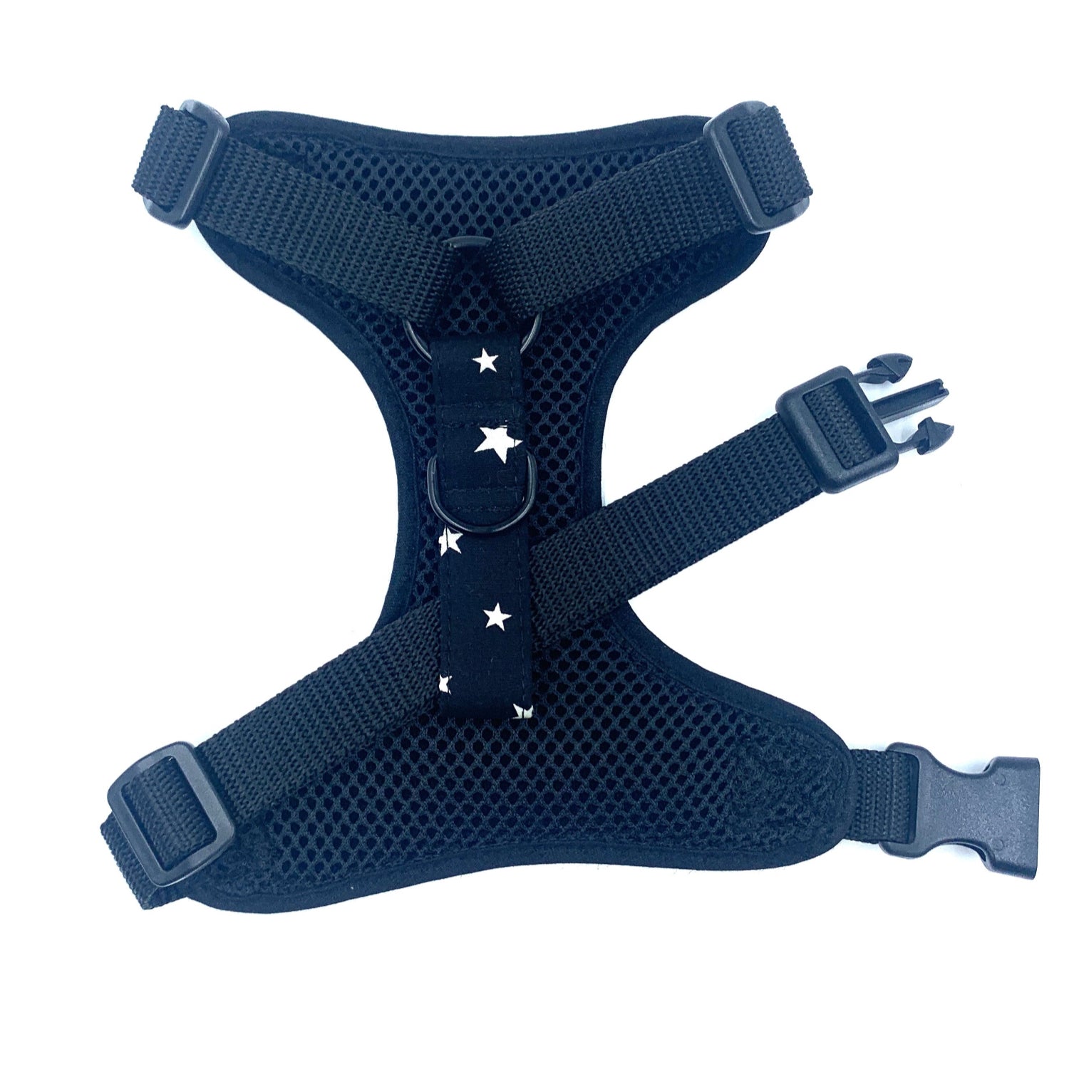 black dog harness with star patterns on a white background