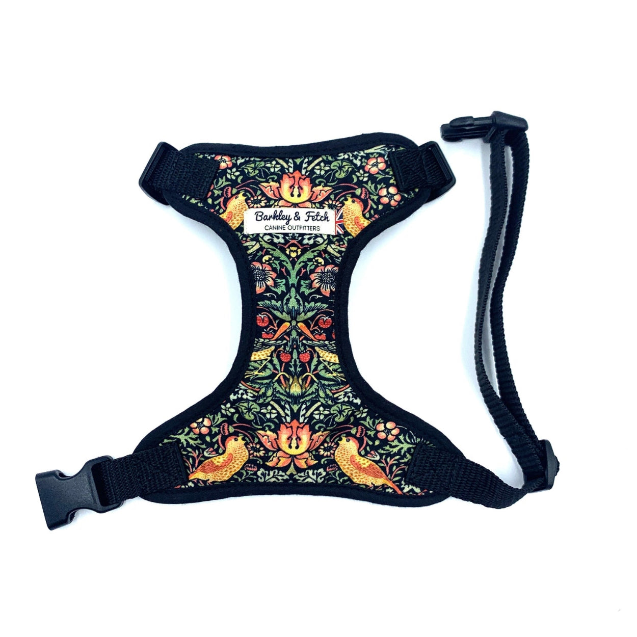 Dog harness with a floral pattern featuring birds and leaves, predominantly black color with adjustable straps and a metal d-ring handmade by Barkley and fetch UK