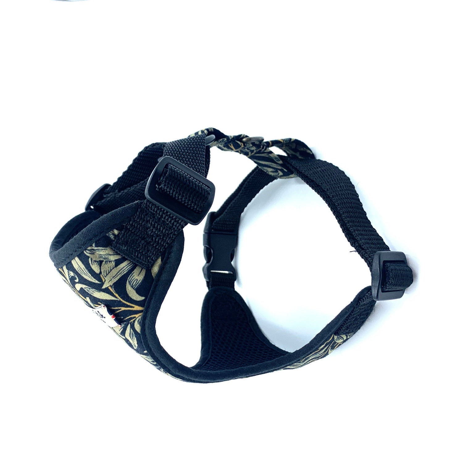 Black dog harness with floral pattern on a white background