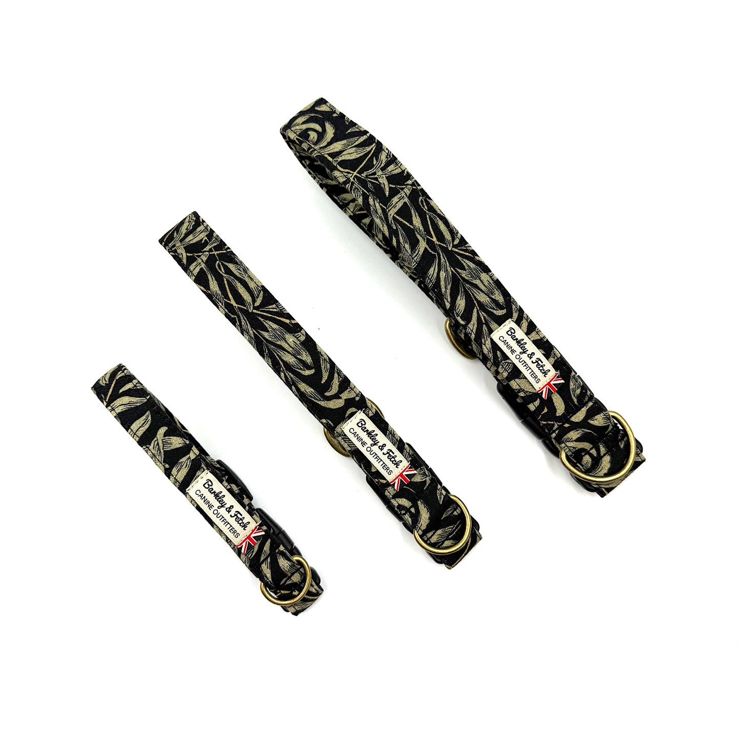 Three black dog collars with gold leaf pattern on a white background