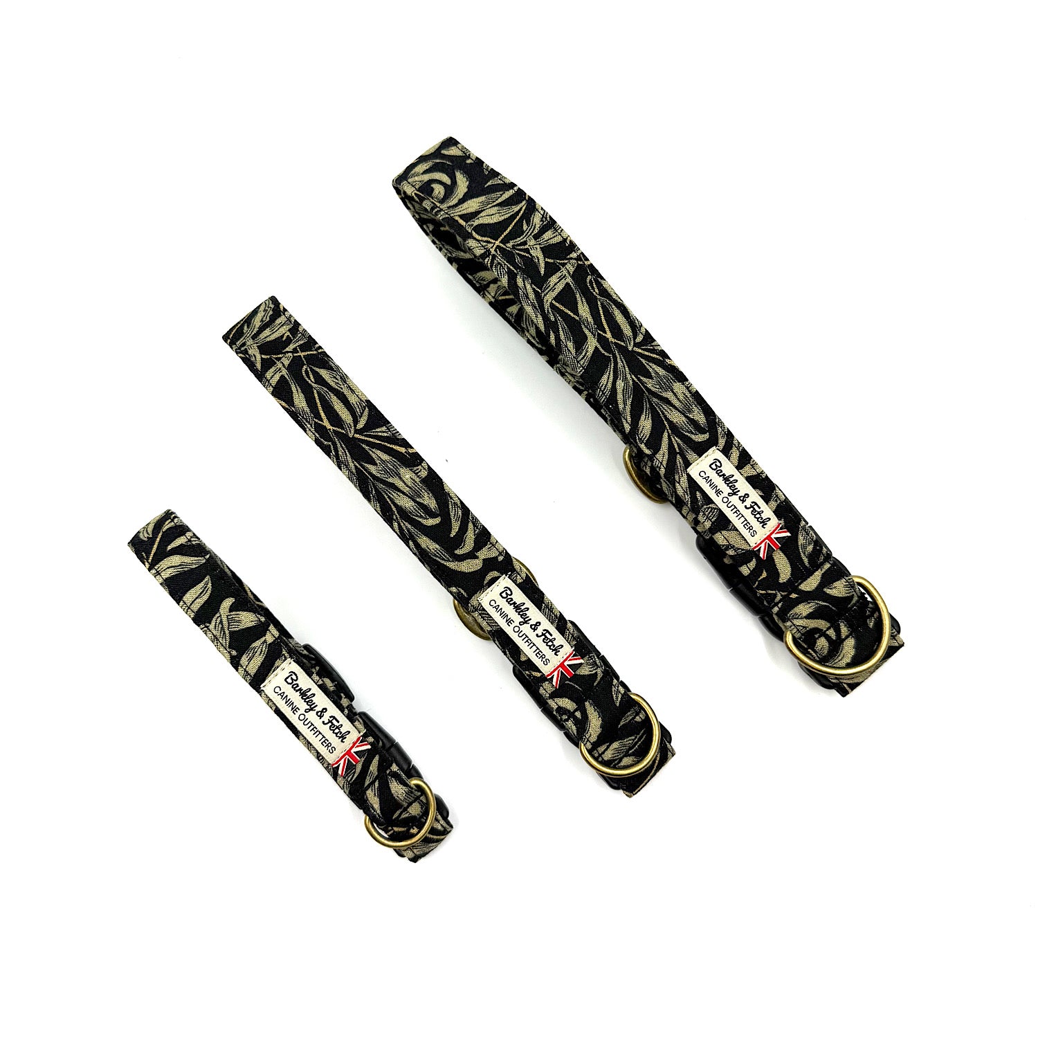 Three black dog collars with gold leaf pattern on a white background