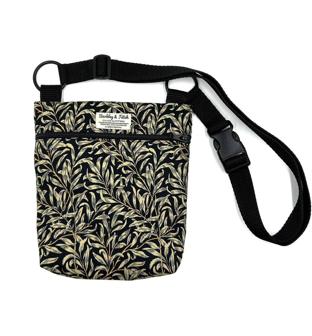 A black and gold William Morris  floral pattern dog walking and treat bag with an adjustable shoulder strap and a label that reads 'Barkley and Fetch'.