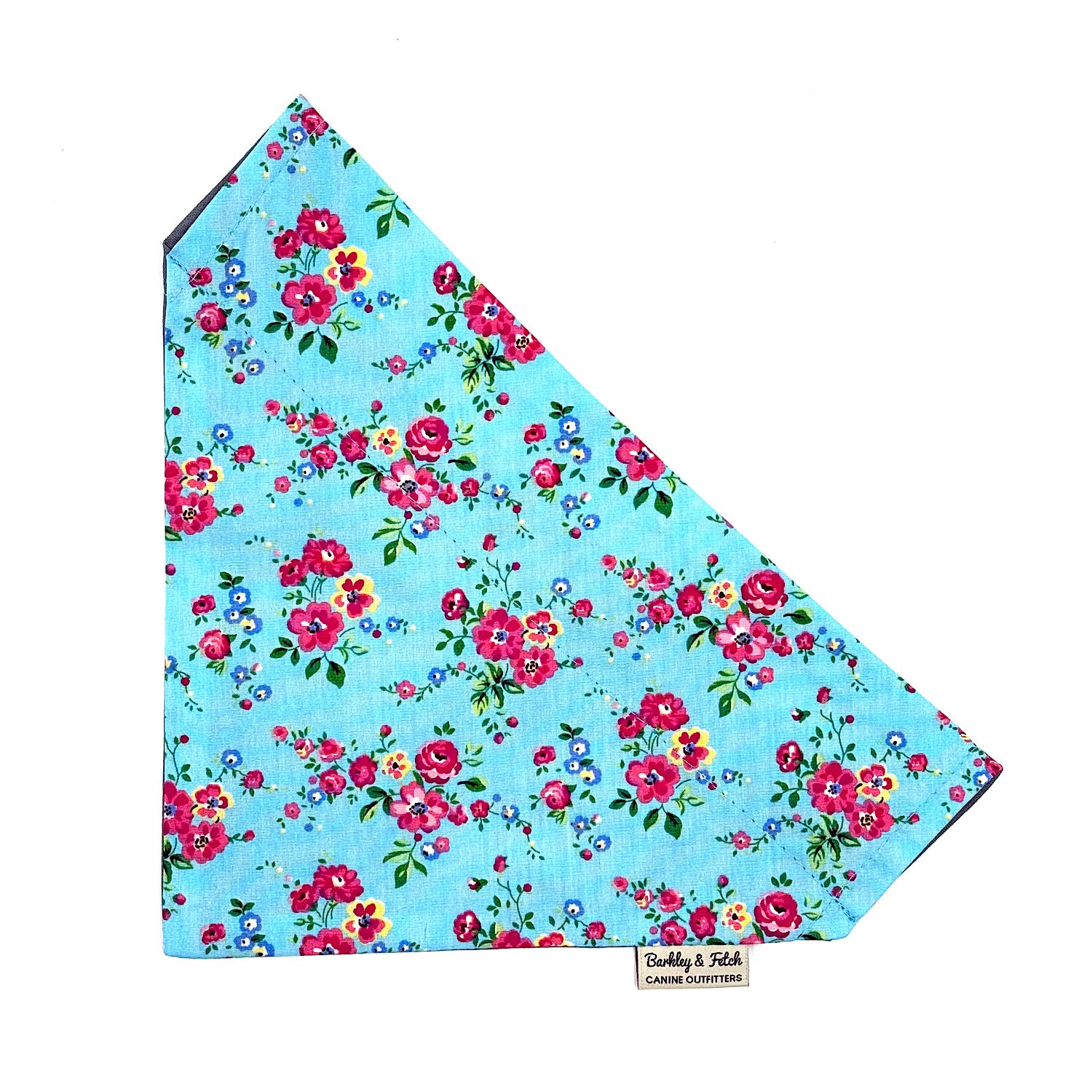 Floral patterned fabric on a blue background with a visible brand label.