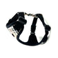 Black dog harness with plaid pattern on a white background