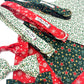 Collection of dog collars and bandanas with Christmas patterns on a white background All handmade in the UK by Barkley and Fetch