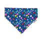 A cobalt blue floral print dog bandana with various colors of flowers on it.