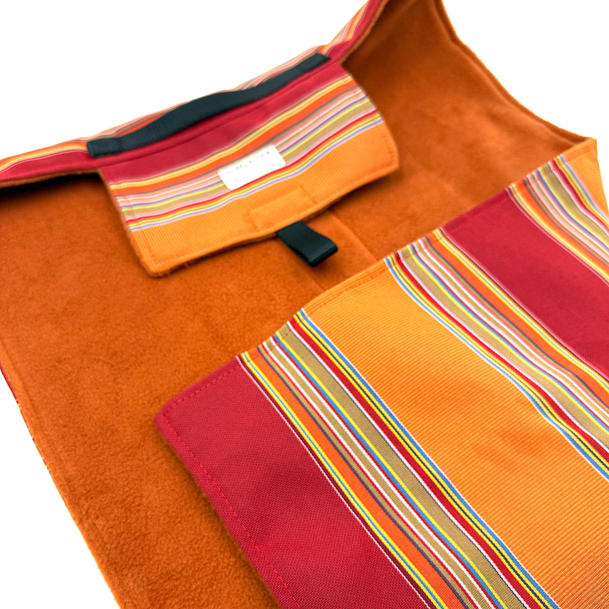 Orange and red fabric with striped pattern on a white background, dog settle mat handmade by Barkley and fetch UK