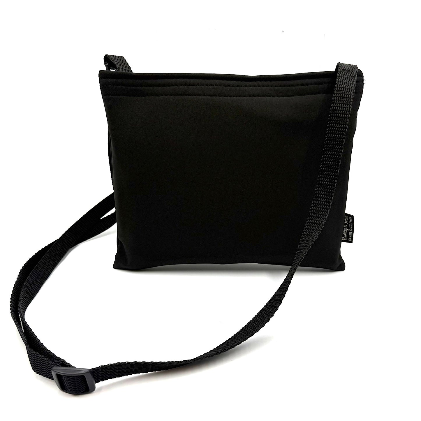 Black colour settle mat folded into a velcro closed bag with a black shoulder strap handmade by Barkley and fetch in the UK, against a white background