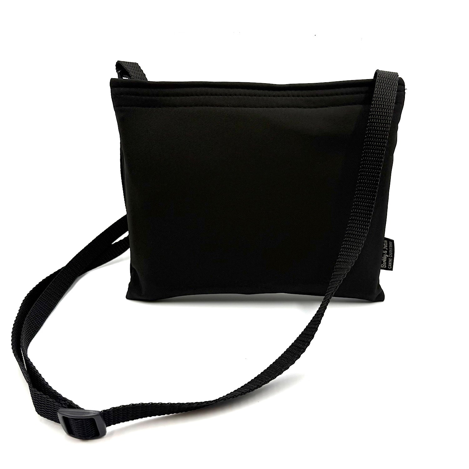Black colour settle mat folded into a velcro closed bag with a black shoulder strap handmade by Barkley and fetch in the UK, against a white background