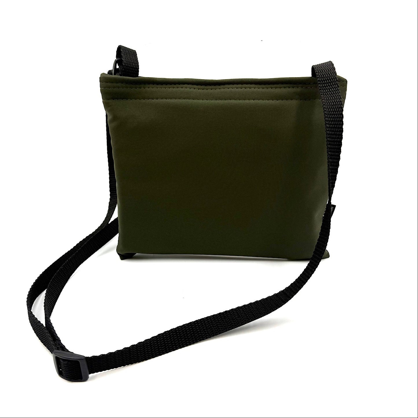 Khaki colour settle mat folded into a velcro closed bag with a black shoulder strap handmade by Barkley and fetch in the UK, against a white background