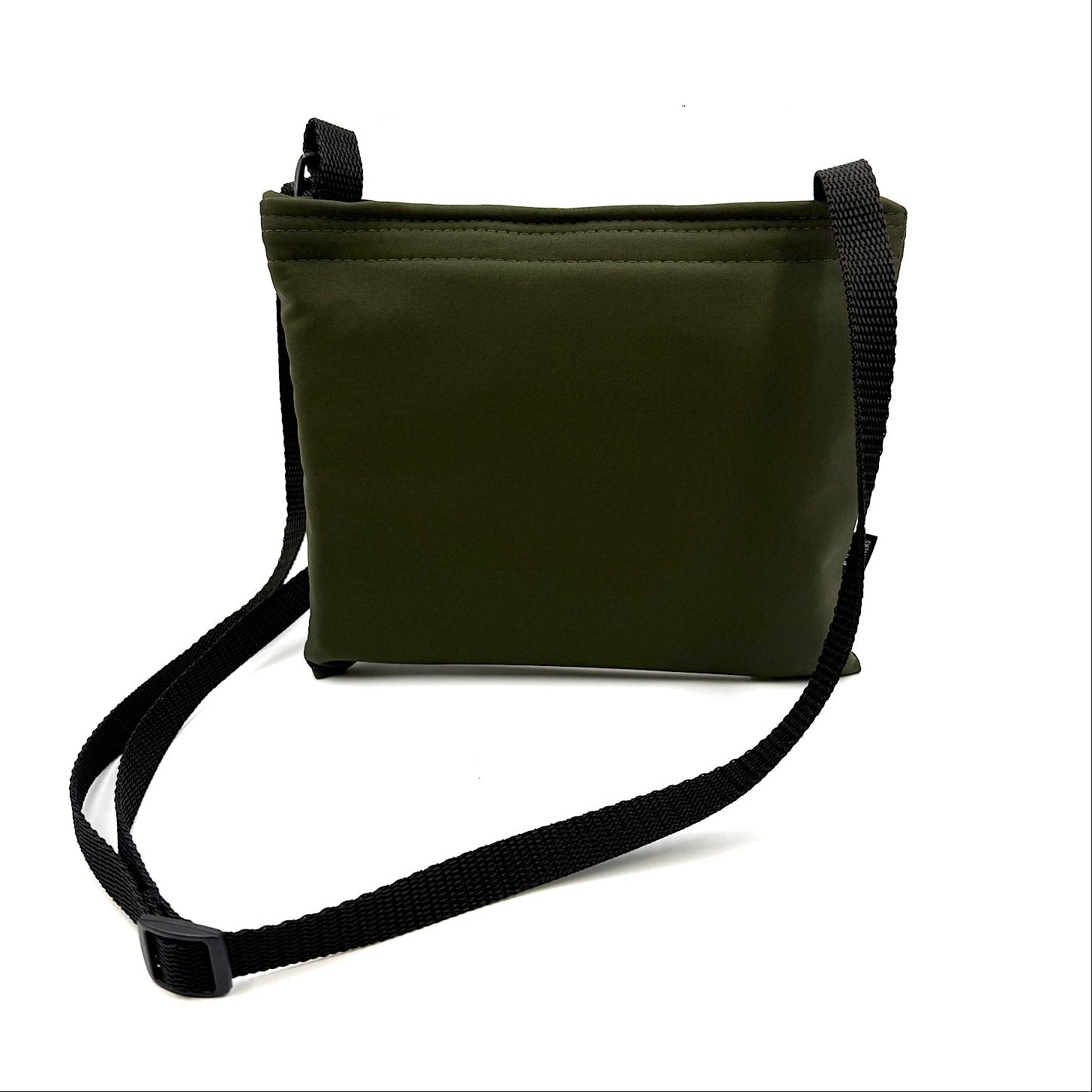 Khaki colour settle mat folded into a velcro closed bag with a black shoulder strap handmade by Barkley and fetch in the UK, against a white background
