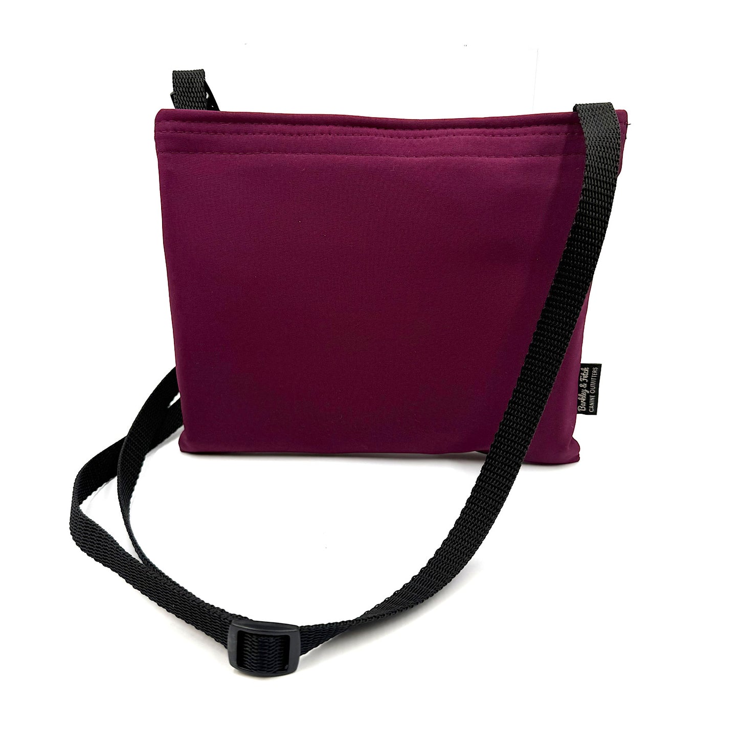 Mulberry colour settle mat folded into a velcro closed bag with a black shoulder strap handmade by Barkley and fetch in the UK, against a white background