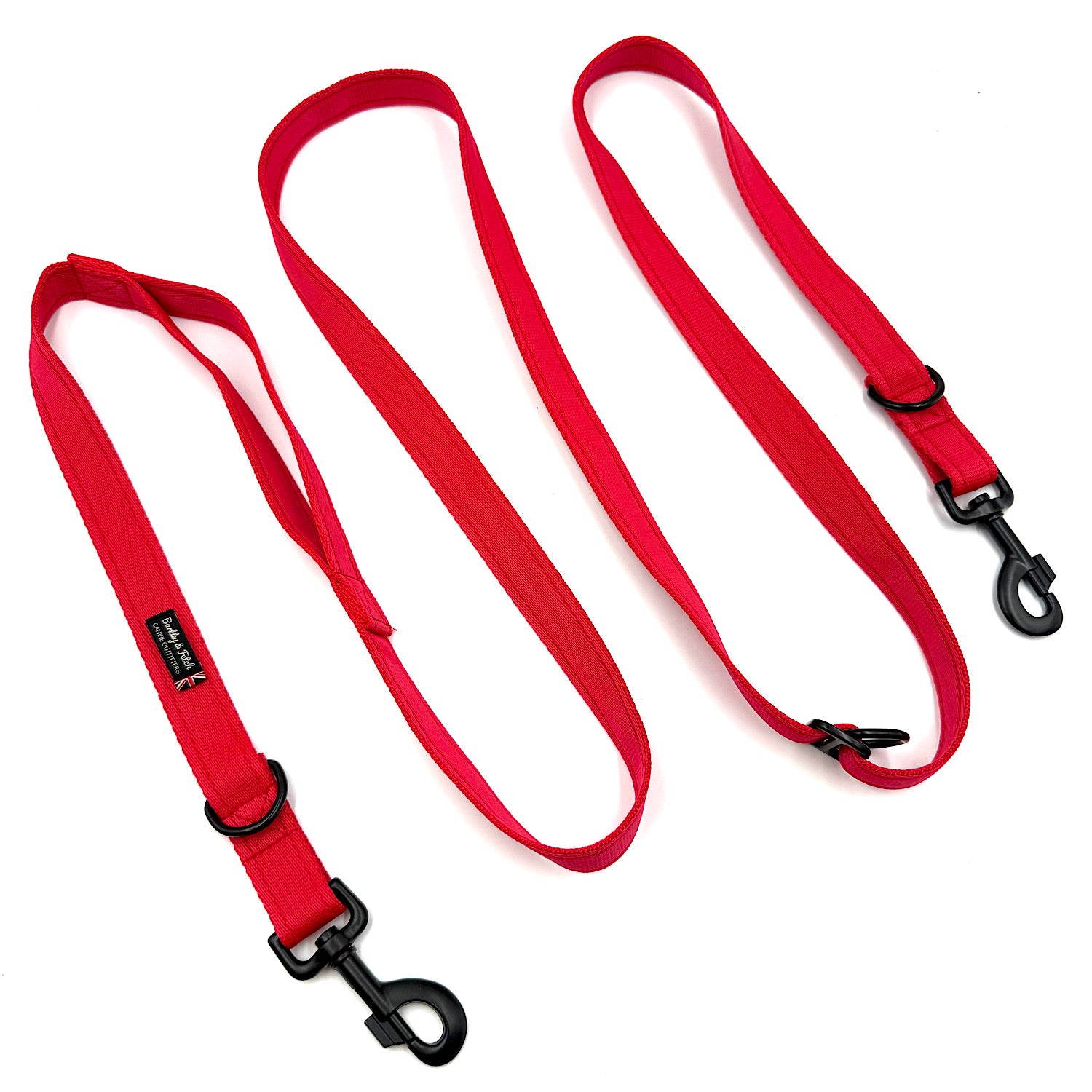 Red dog leash with black clips on a white background