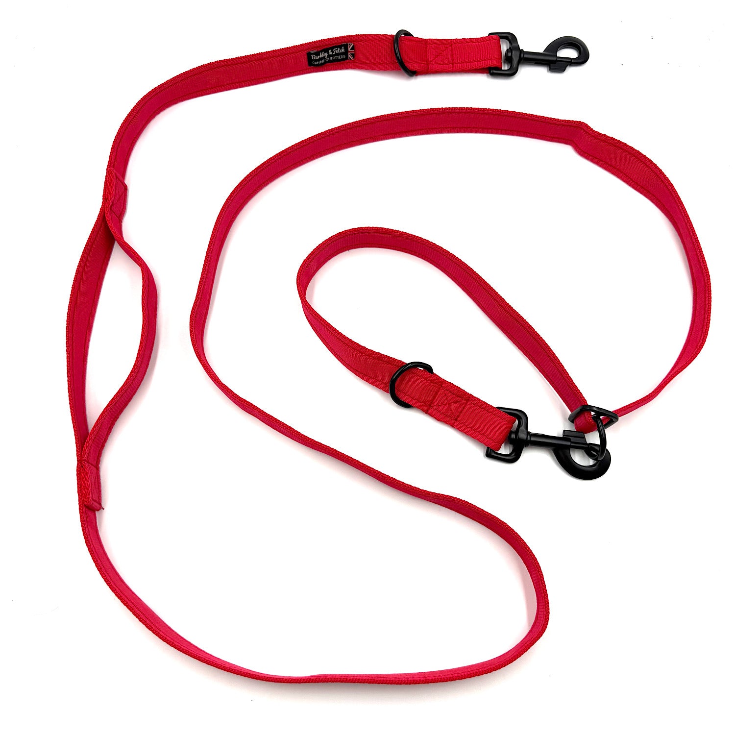 Red dog leash with black clips on a white background