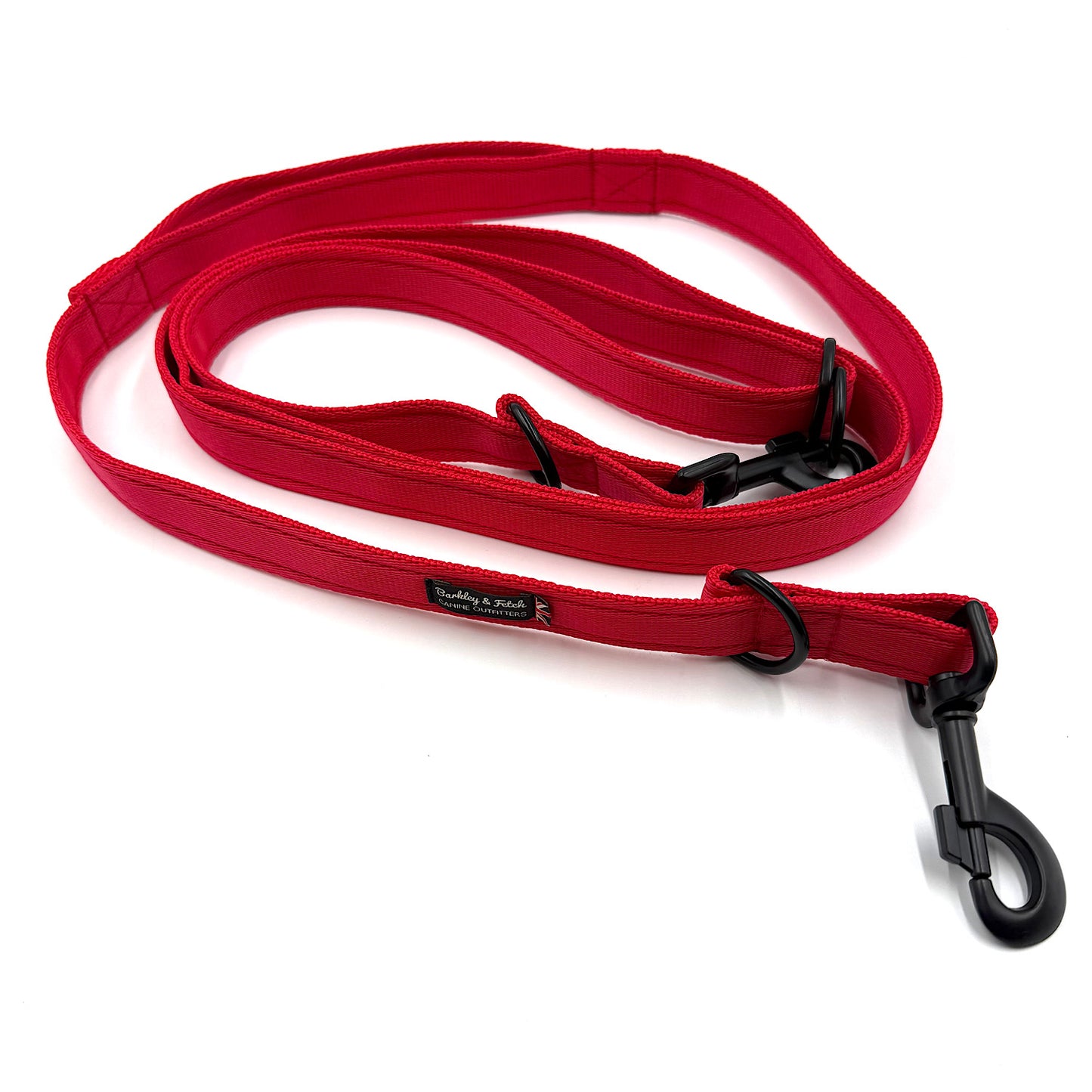 Red dog leash with black clip on a white background