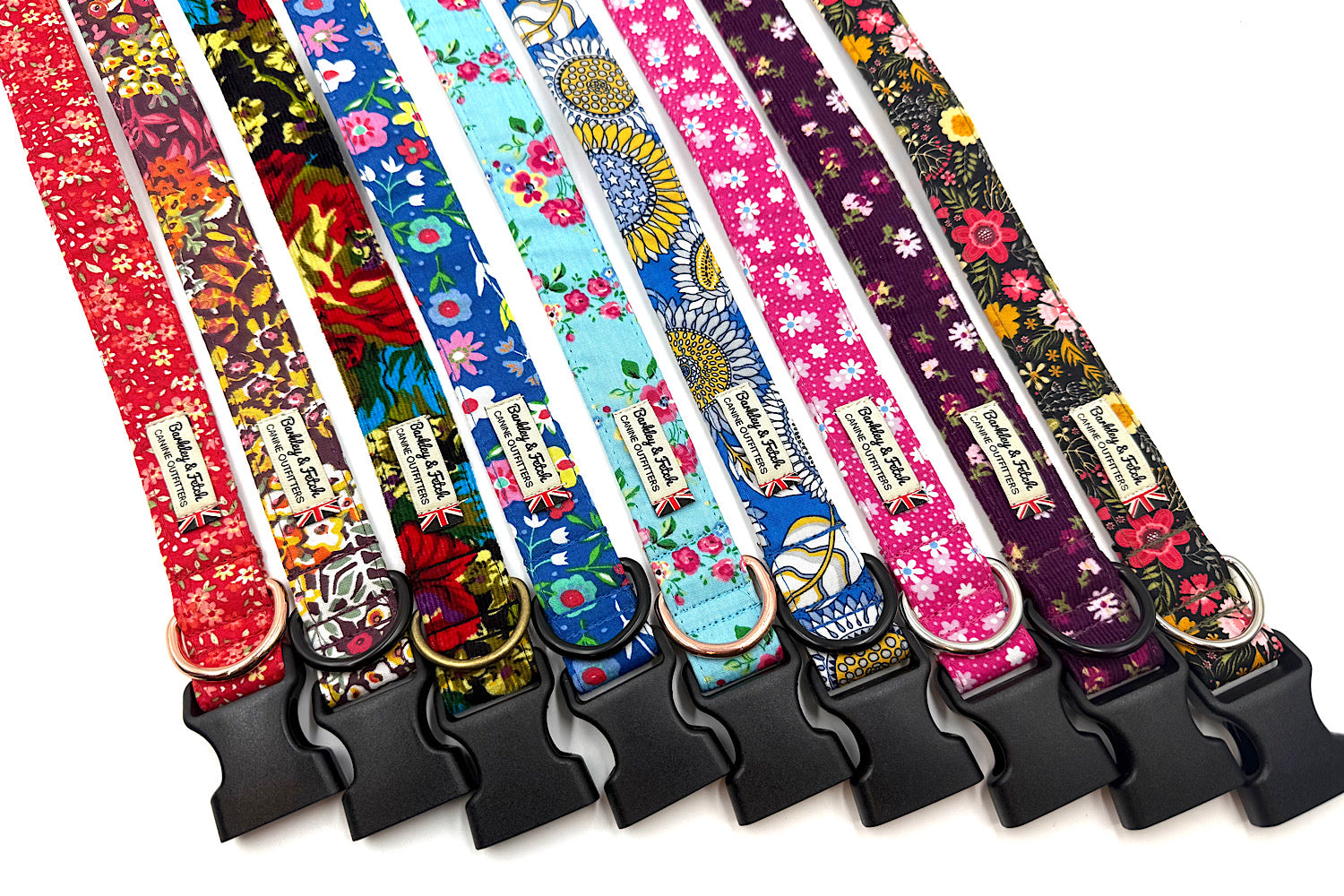 Set of colorful dog collars with floral and abstract patterns on a white background