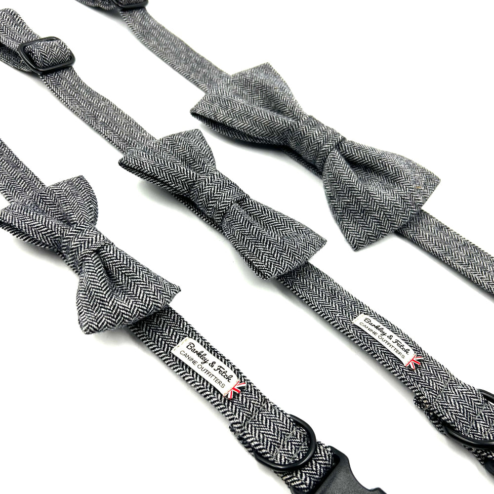 Gray herringbone bow ties and suspenders with a brand label on a white background