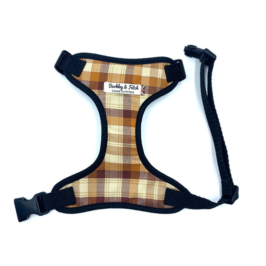 A plaid pattern dog harness with black straps and a label showing the brand name 'Bubba & Fletch'.