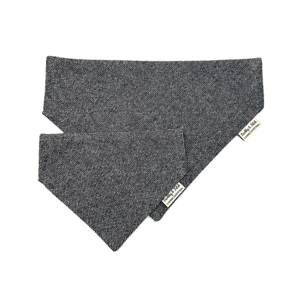 Grey dog bandana with a brand tag on a white background