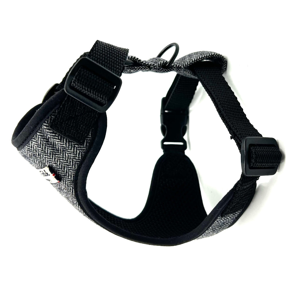 Black and gray dog harness on a white background