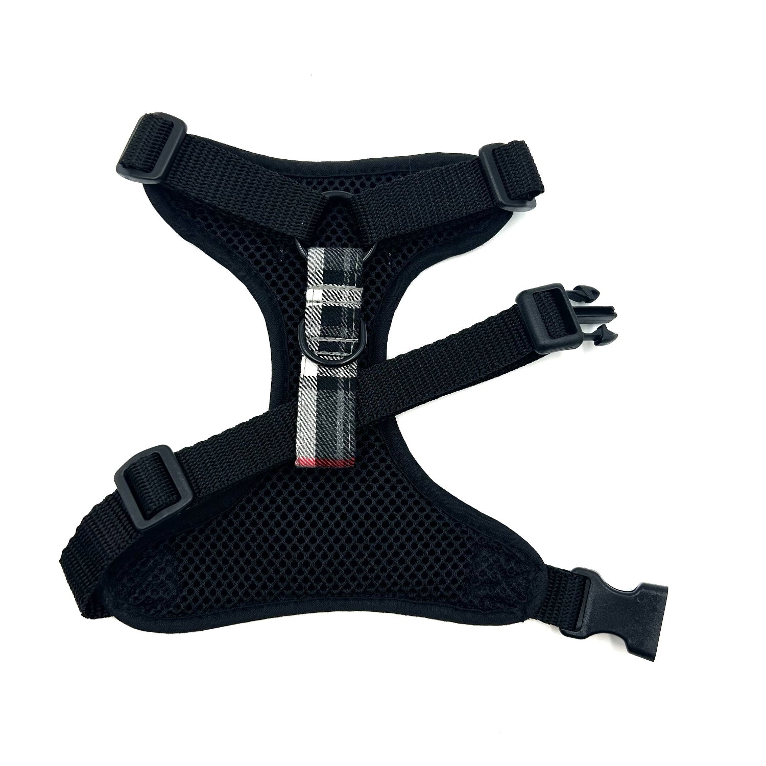 Black dog harness with a metal buckle on a white background