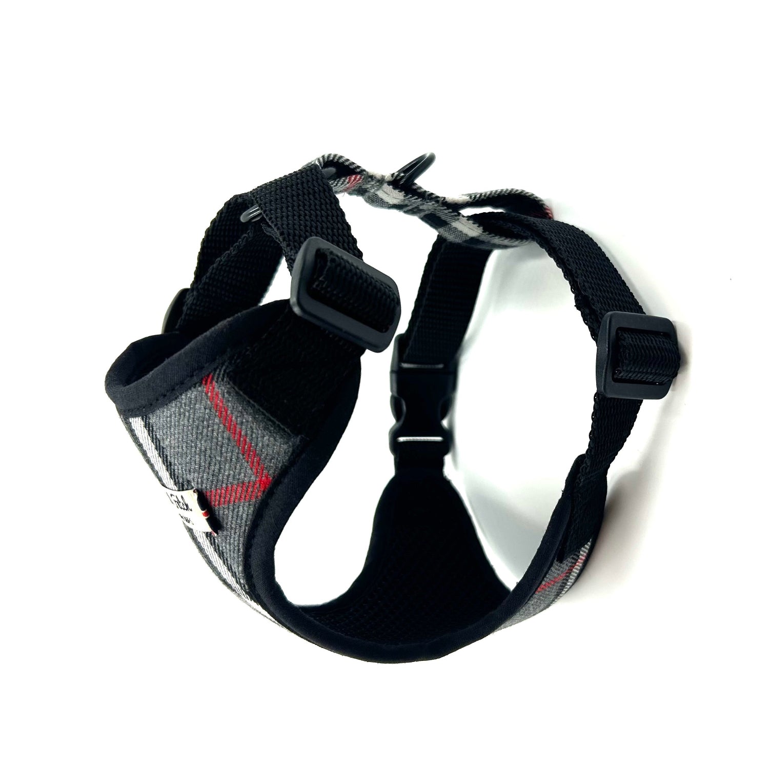 Black dog harness with a visible brand logo on a white background