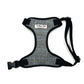 Gray plaid dog harness with black straps on a white background