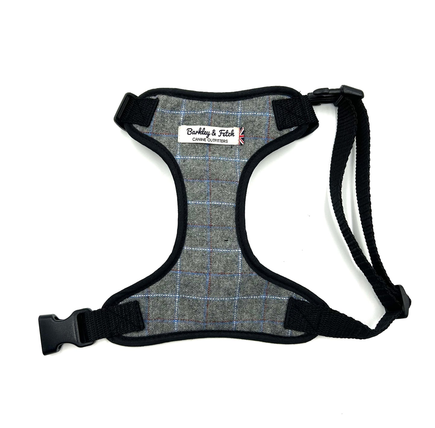 Gray plaid dog harness with black straps on a white background