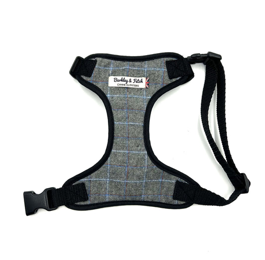 Gray plaid dog harness with black straps on a white background