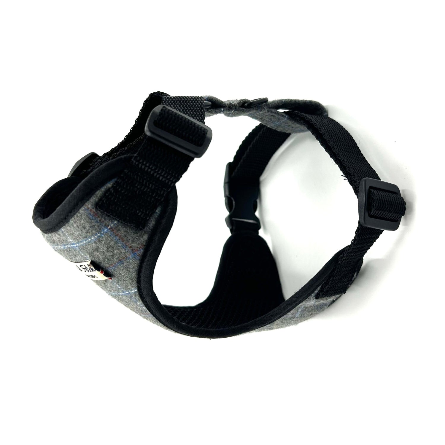 Black and grey dog harness on a white background