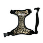 Leopard print dog harness with black straps on a white background