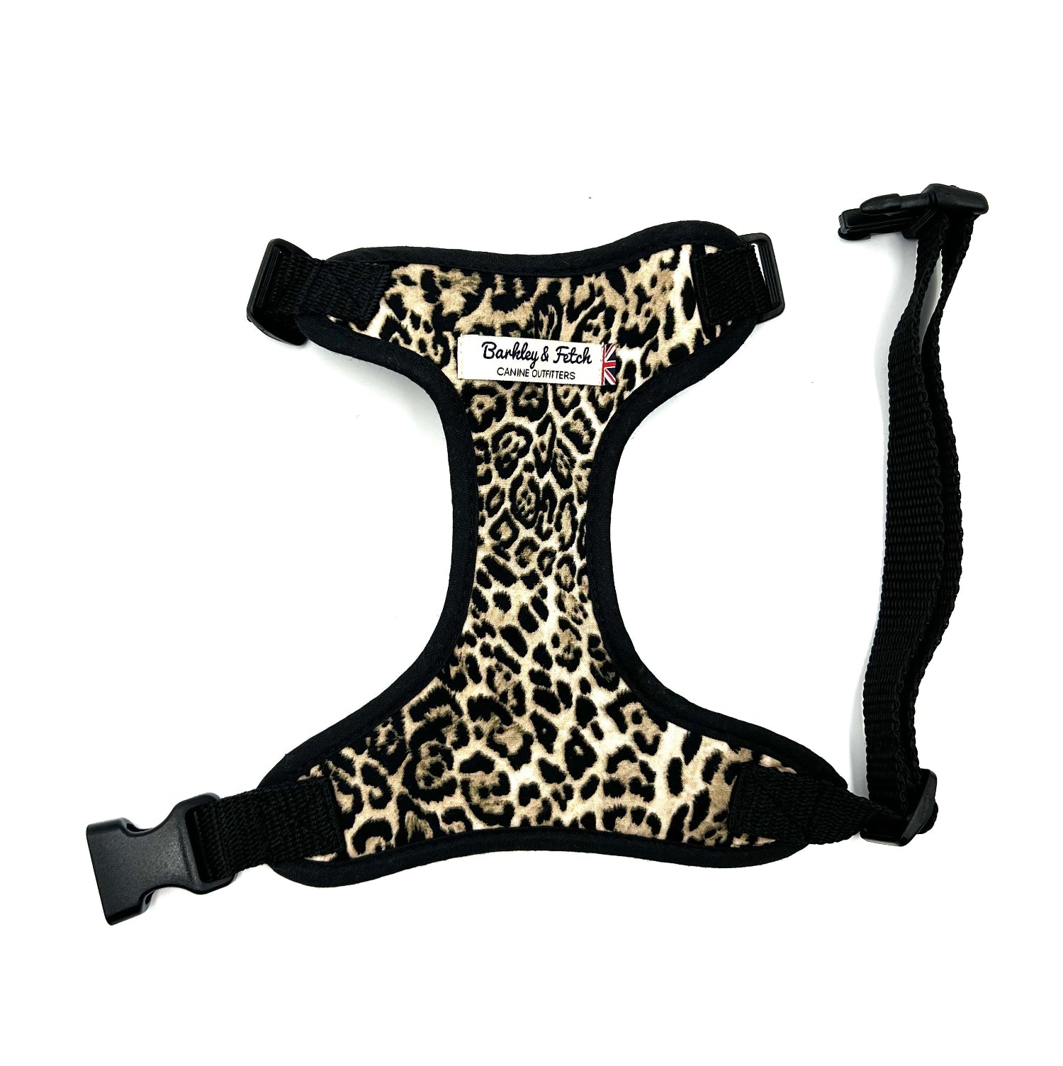 Leopard print dog harness with black straps on a white background