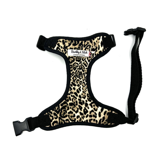 Leopard print dog harness with black straps on a white background